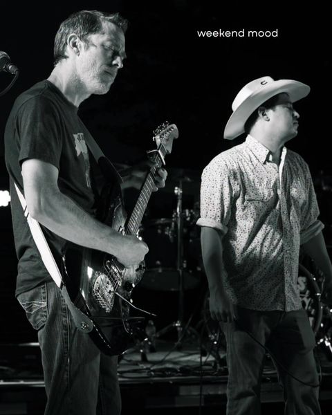 Two band members performing together
