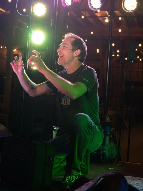 Lead vocals under green stage lights